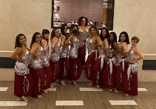 Anne Darrow, MD, MA poses with dance troupe.
